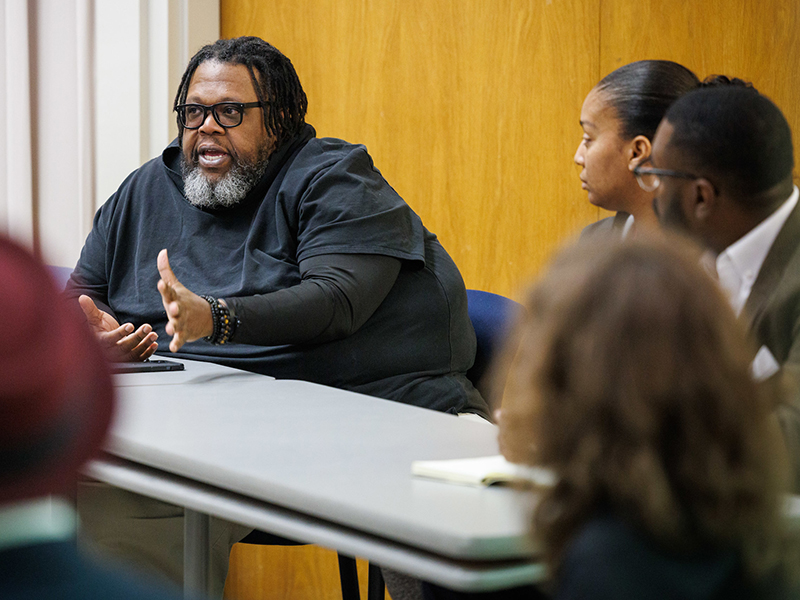 Charles Smith speaks during the panel discussion of Ewoodzie's book.